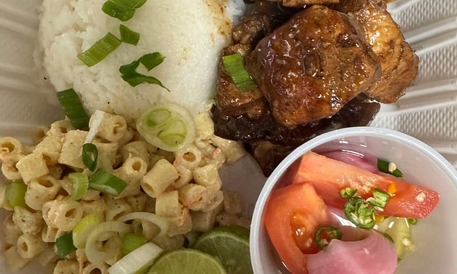 Pork adobo plate with rice, macaroni salad and pickled vegetables